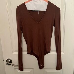 Naked wardrobe mocha brown colored V neck long sleeved body suit.